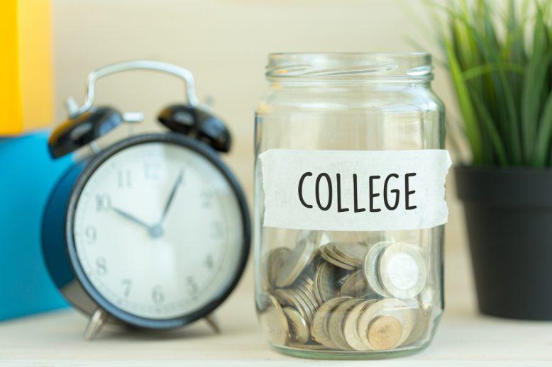 change in a jar labeled college and an alarm clock
